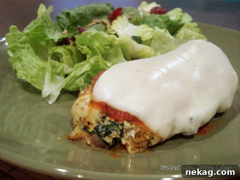 Close-up of baked Chicken & Spinach Rollatini with melted cheese and fresh herbs
