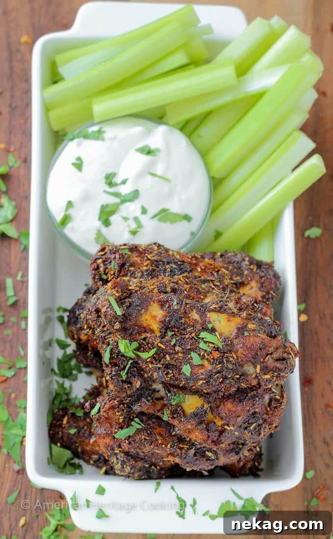 Signature Spiced Oven Baked Wings 5 Spice Rack Dry Rubbed Baked Chicken Wings - A platter of cooked wings with fresh cilantro