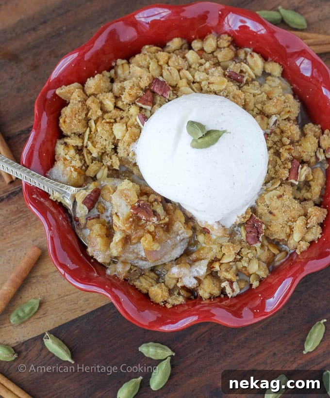 Close-up of the golden-brown, crispy topping of the Cardamom Pear Crisp, showing the oats and sugar granules.