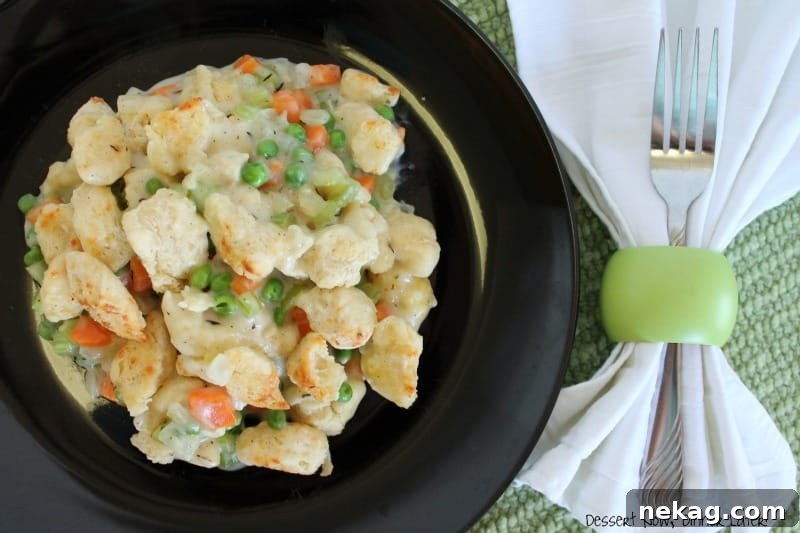 Golden Biscuit Topped Chicken Pot Pie 4 A serving of chicken pot pie crumble scooped onto a plate, showing the golden biscuit chunks and creamy filling.