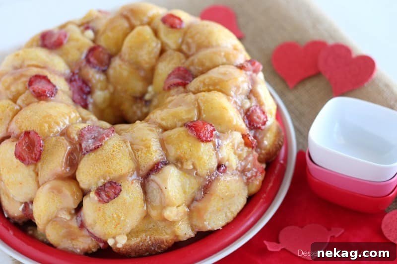 Freshly baked Vanilla Strawberry Monkey Bread inverted onto a serving plate
