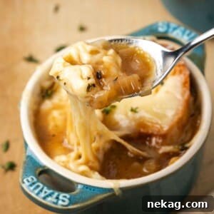 perfect bite of french onion soup on spoon.