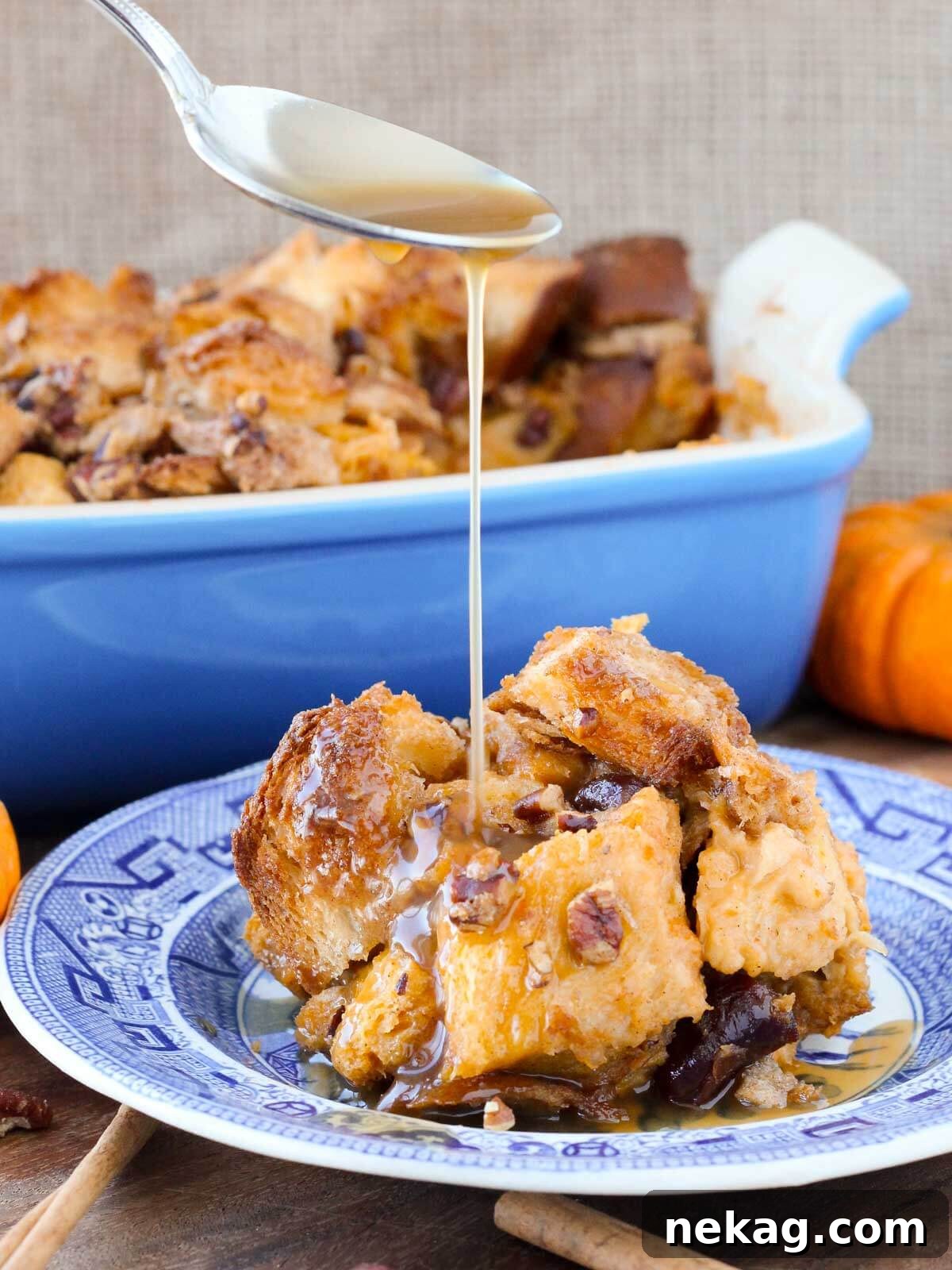 Pumpkin bread pudding generously drizzled with a smooth bourbon sauce, ready to be served.