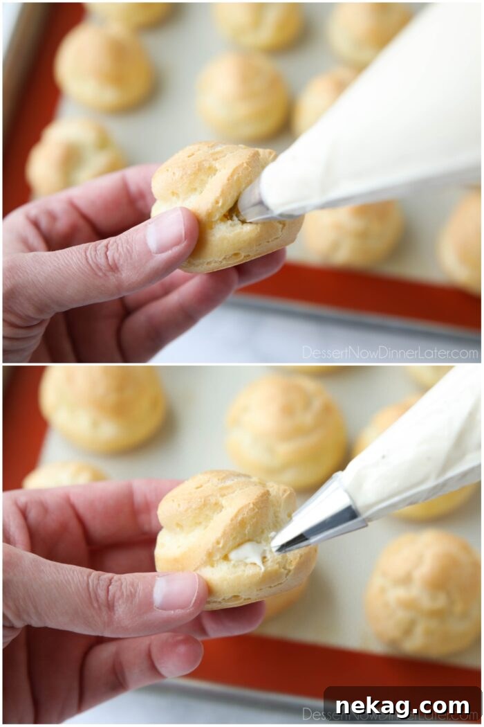 Holiday Eggnog Cream Puffs 12 A close-up of a hand holding a piping bag, carefully filling a cream puff with whipped eggnog pastry cream.