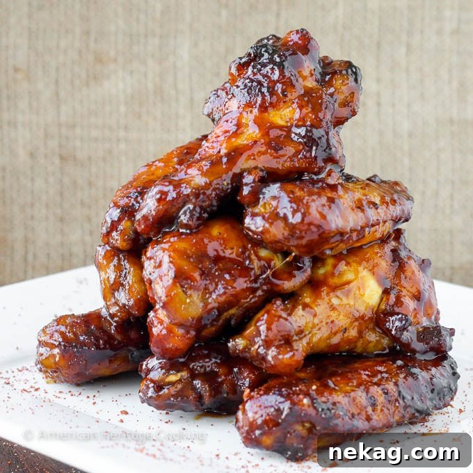 Sweet Heat Crispy Baked Wings 3 A beautiful pile of baked chicken wings, glistening with a perfectly thick and rich chipotle maple sauce.