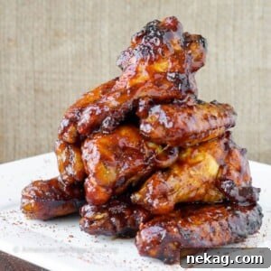 A pile of baked chicken wings in a perfectly thick sauce.