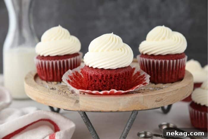 A tantalizing close-up of a red velvet cupcake, its wrapper gently peeled back to showcase the exquisite fluffy and moist cake texture.