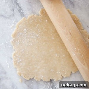 Crisco pie dough rolled on a marble surface, perfectly smooth and round.