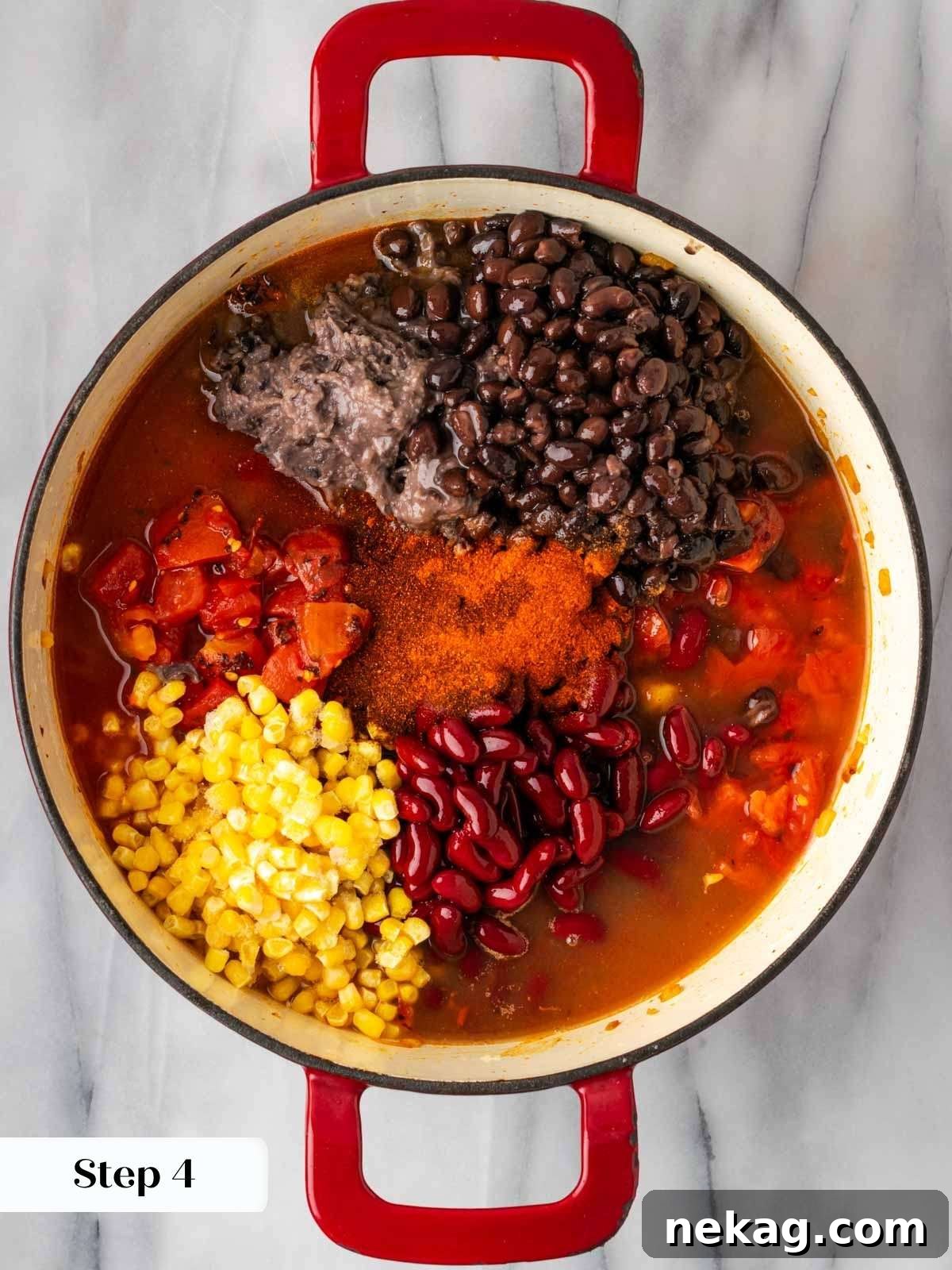 Adding hearty beans and sweet corn to the simmering chili pot, completing the main ingredients.