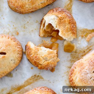 Apple Hand Pies arranged on a baking sheet, ready to be enjoyed as bite-sized autumn treats.