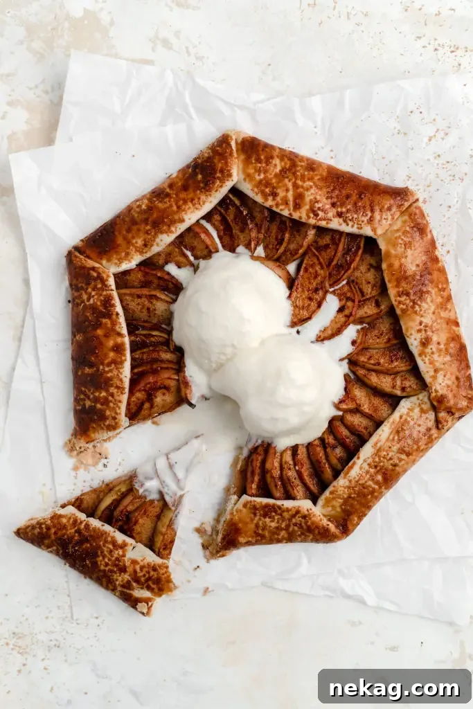A rustic and elegant apple galette, beautifully golden and folded around its spiced apple filling.