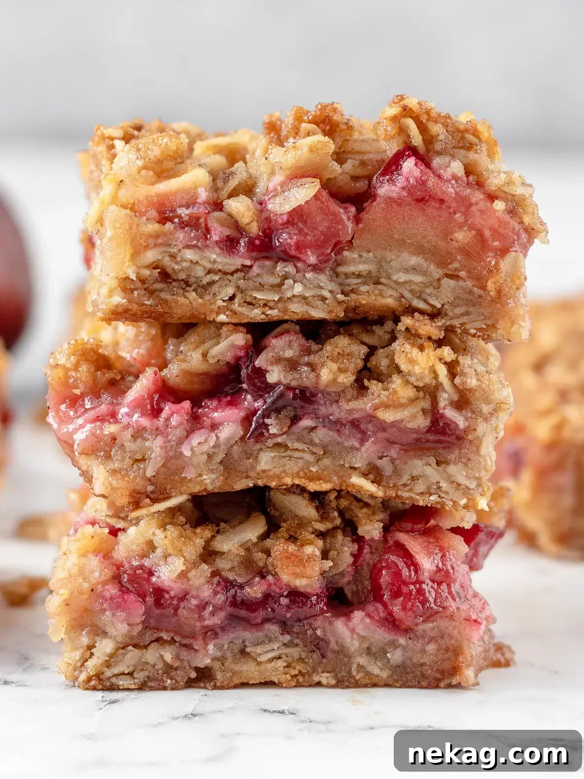A stack of delicious apple plum crumble bars, showcasing their crumbly topping and fruity layers.