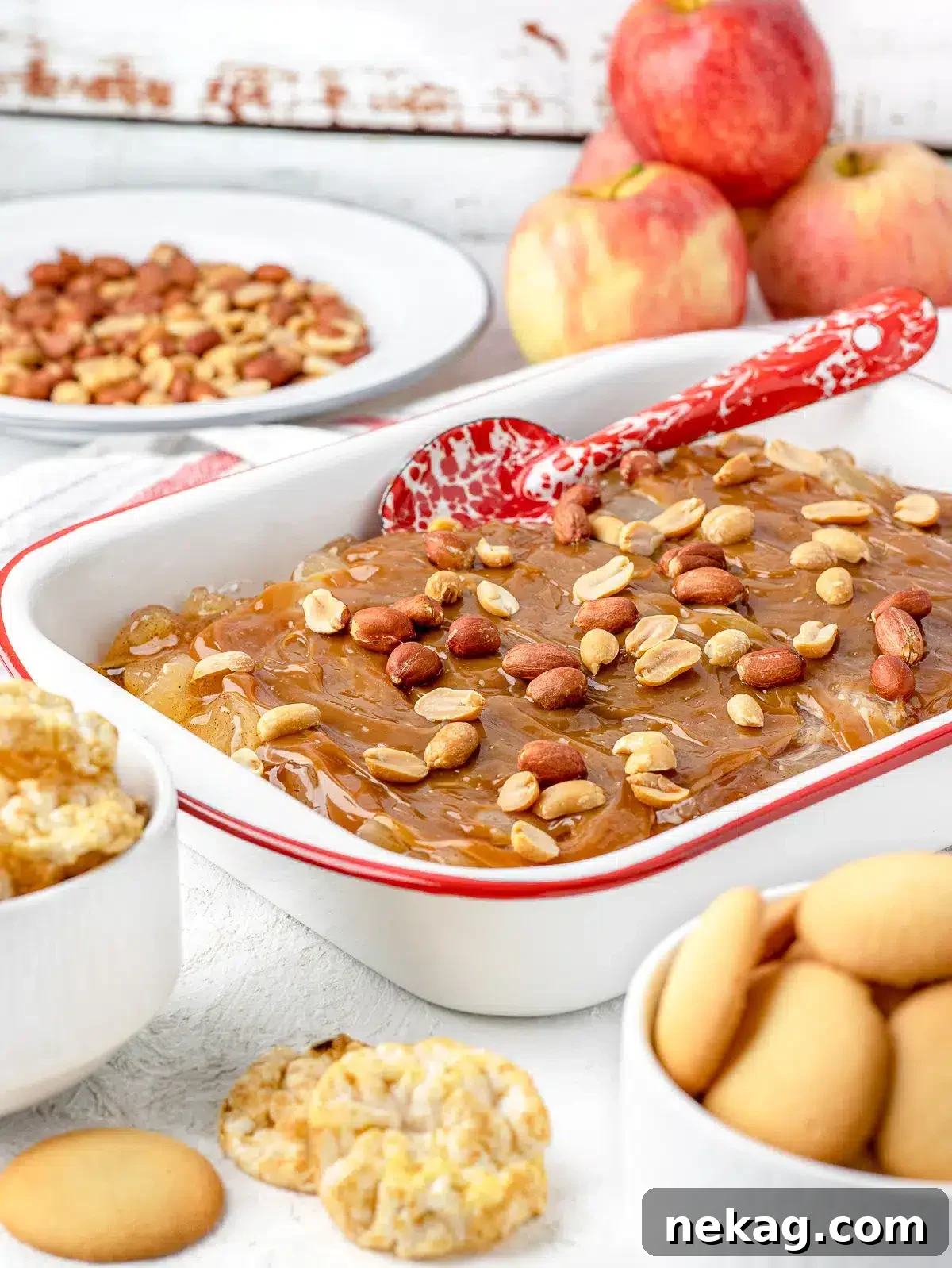 A beautiful caramel apple pie dip, generously topped with caramel sauce, ready to be served with dippers.