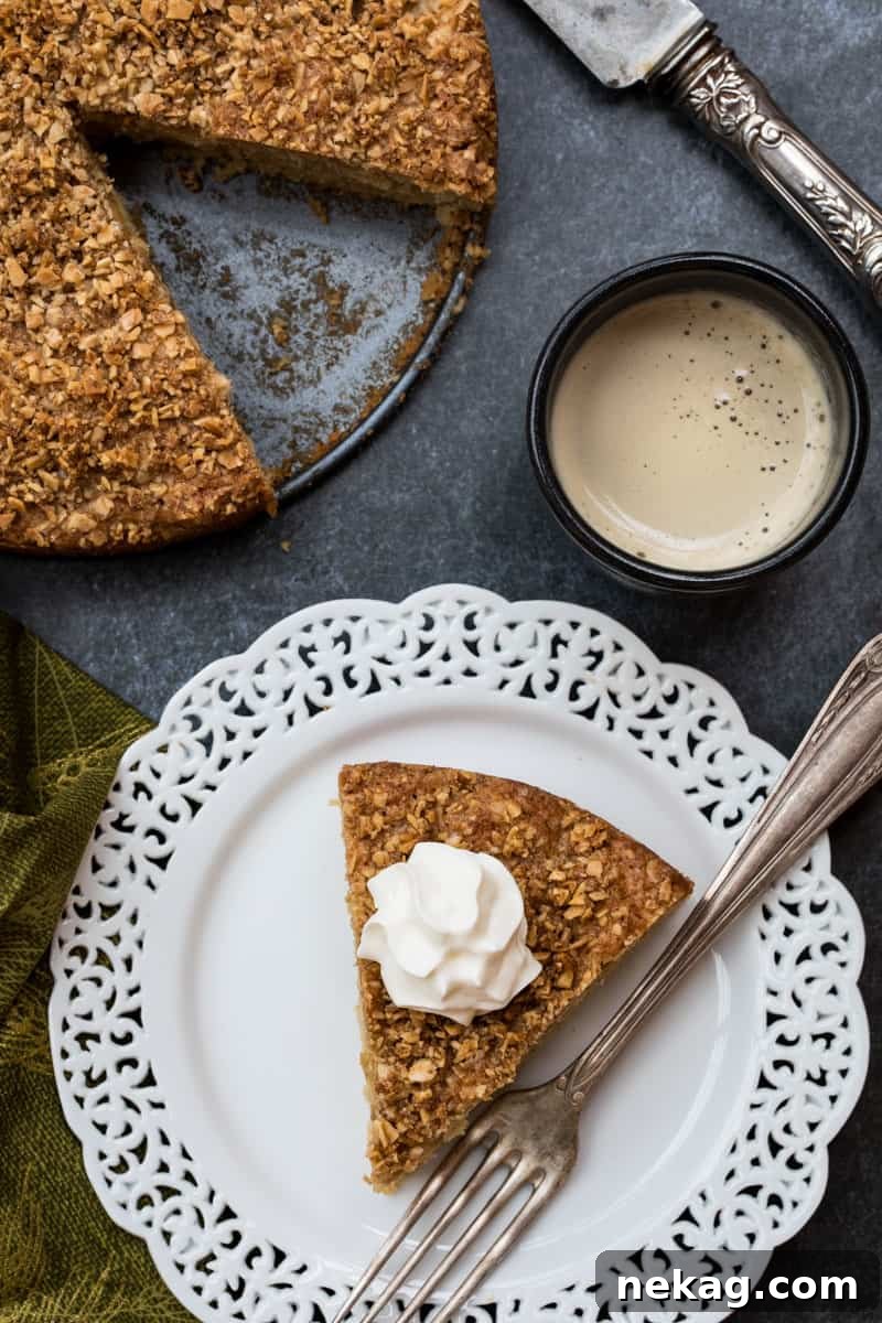 A delightful Apple Almond Cake, showcasing its moist texture and almond crumble topping.