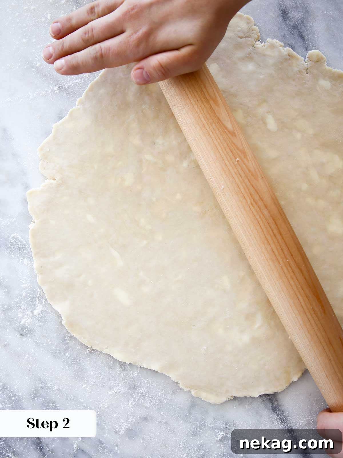 Weaving a Perfect Pie Crust Lattice 4 rolling pie dough thin on marble.