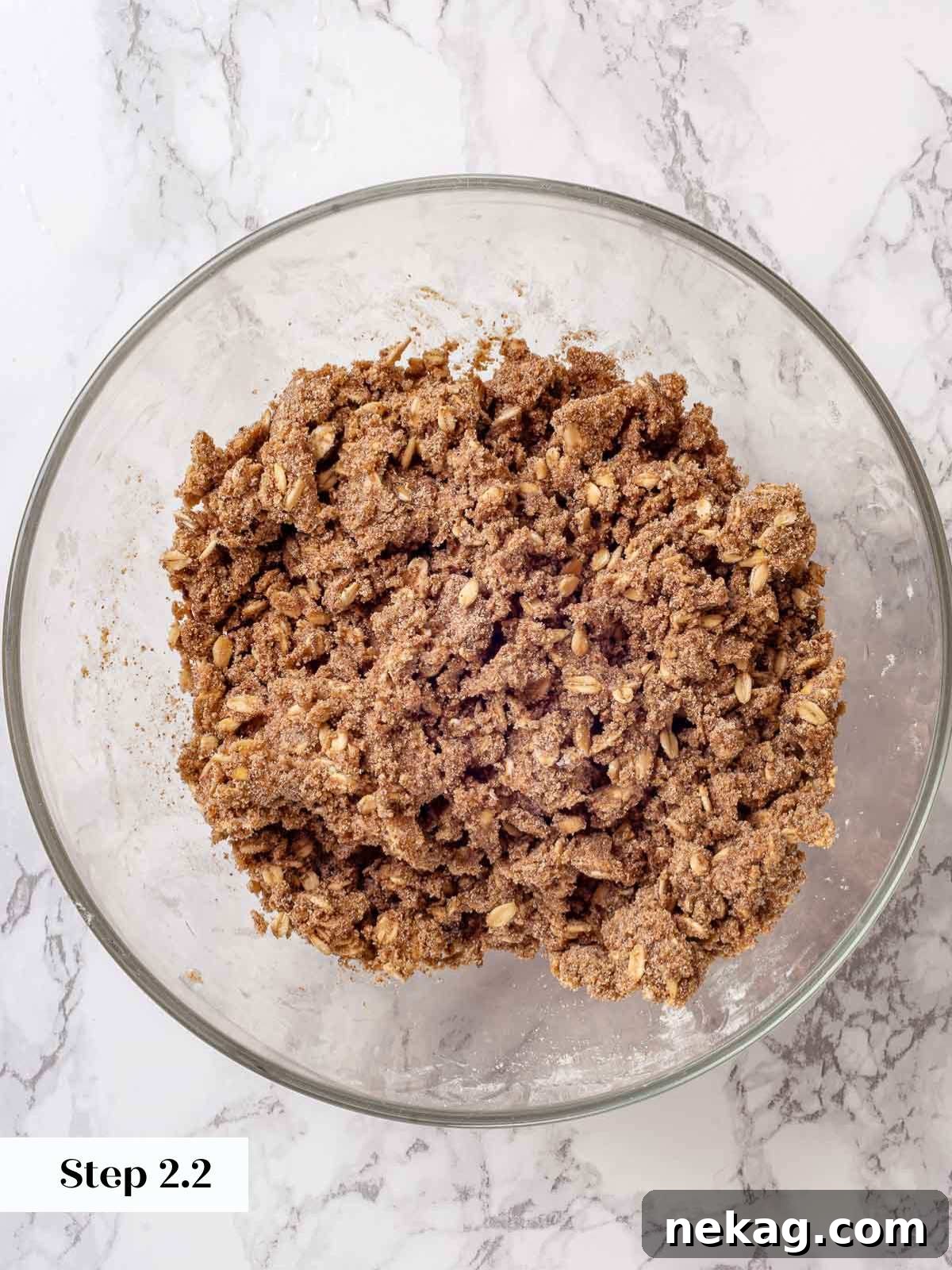 Effortless Golden Apple Crisp 7 Apple crisp topping ingredients mixed together with butter, forming a crumbly streusel.
