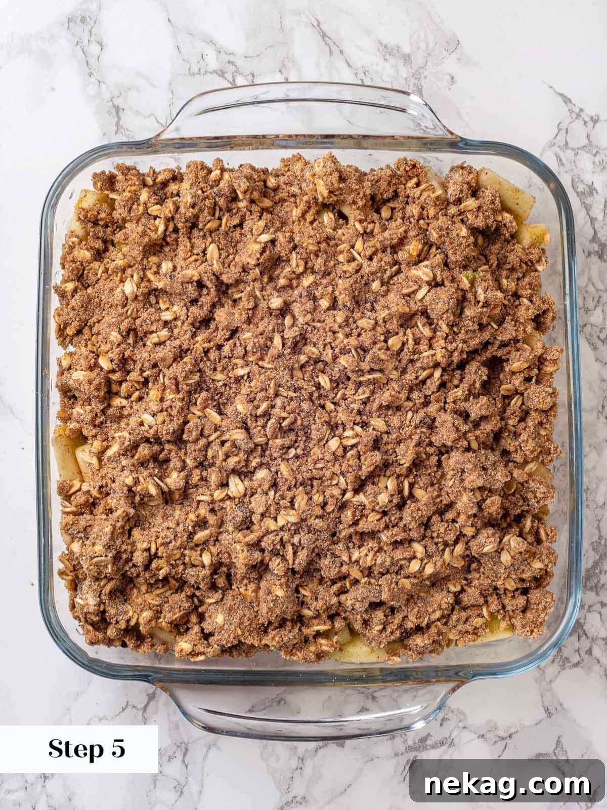 Effortless Golden Apple Crisp 8 Unbaked apple crisp assembled in a baking dish, ready for the oven.