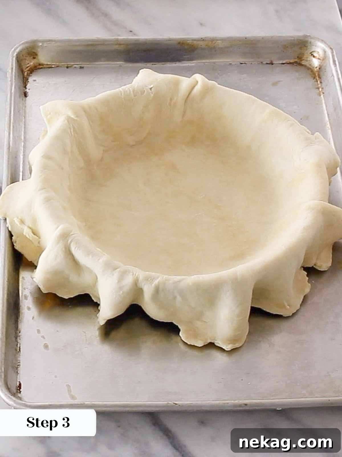 Mastering Blind Baking for a Perfect Pie Crust 5 Overlapping pie dough in a pie plate, showing excess dough over the edges.