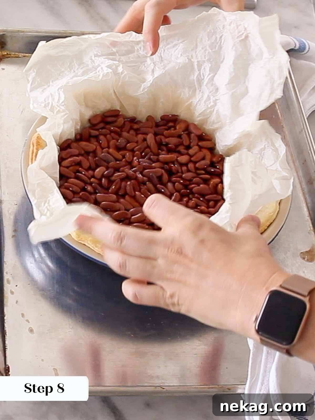 Mastering Blind Baking for a Perfect Pie Crust 9 Carefully removing pie weights and parchment paper from a blind-baked crust.