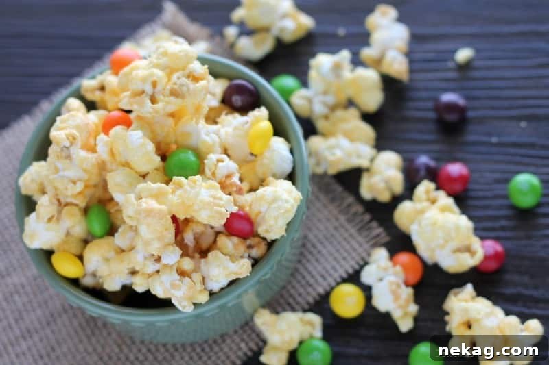 A large bowl of Pot of Gold Popcorn mixed with rainbow Skittles, ready to be served.
