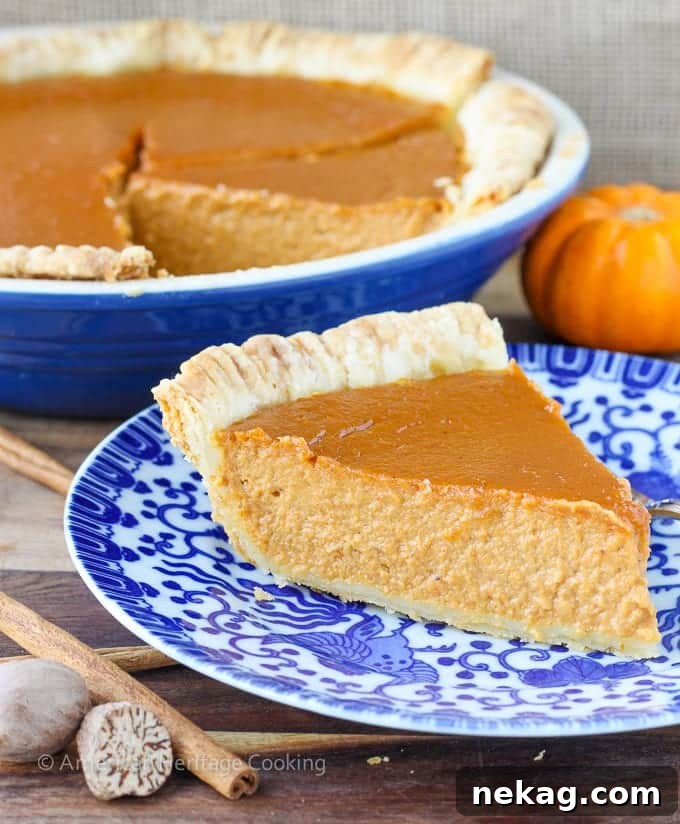 Elevated Pumpkin Pie Classic 3 A close-up of the perfectly baked Classic Pumpkin Pie with a Twist, showcasing its smooth, dense texture and golden-brown crust.
