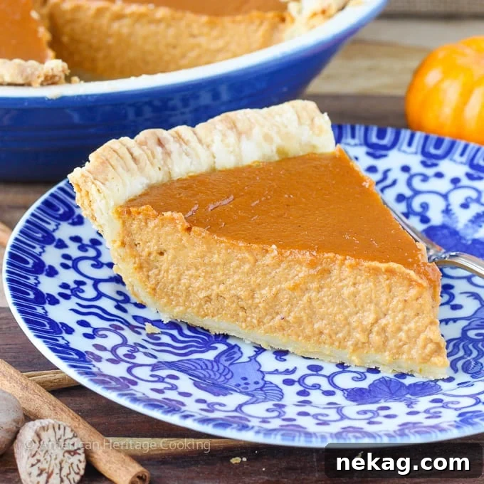 Elevated Pumpkin Pie Classic 5 A slice of Classic Pumpkin Pie with a Twist, showing the custard's texture and a golden crust, ready to be enjoyed.