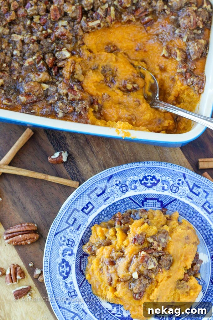 Smart Sweet Potato Casserole 6 A spoon scooping a generous portion of the lightened sweet potato casserole, highlighting its texture