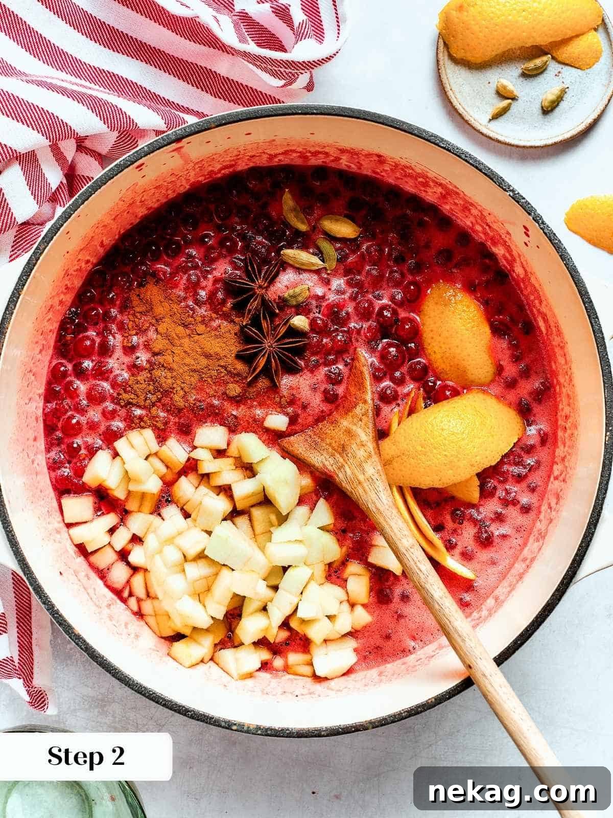 Ruby Red Holiday Delight 8 A saucepan of bubbling cranberries with whole warm spices infusing flavor during the extended cooking process, creating a rich aroma.