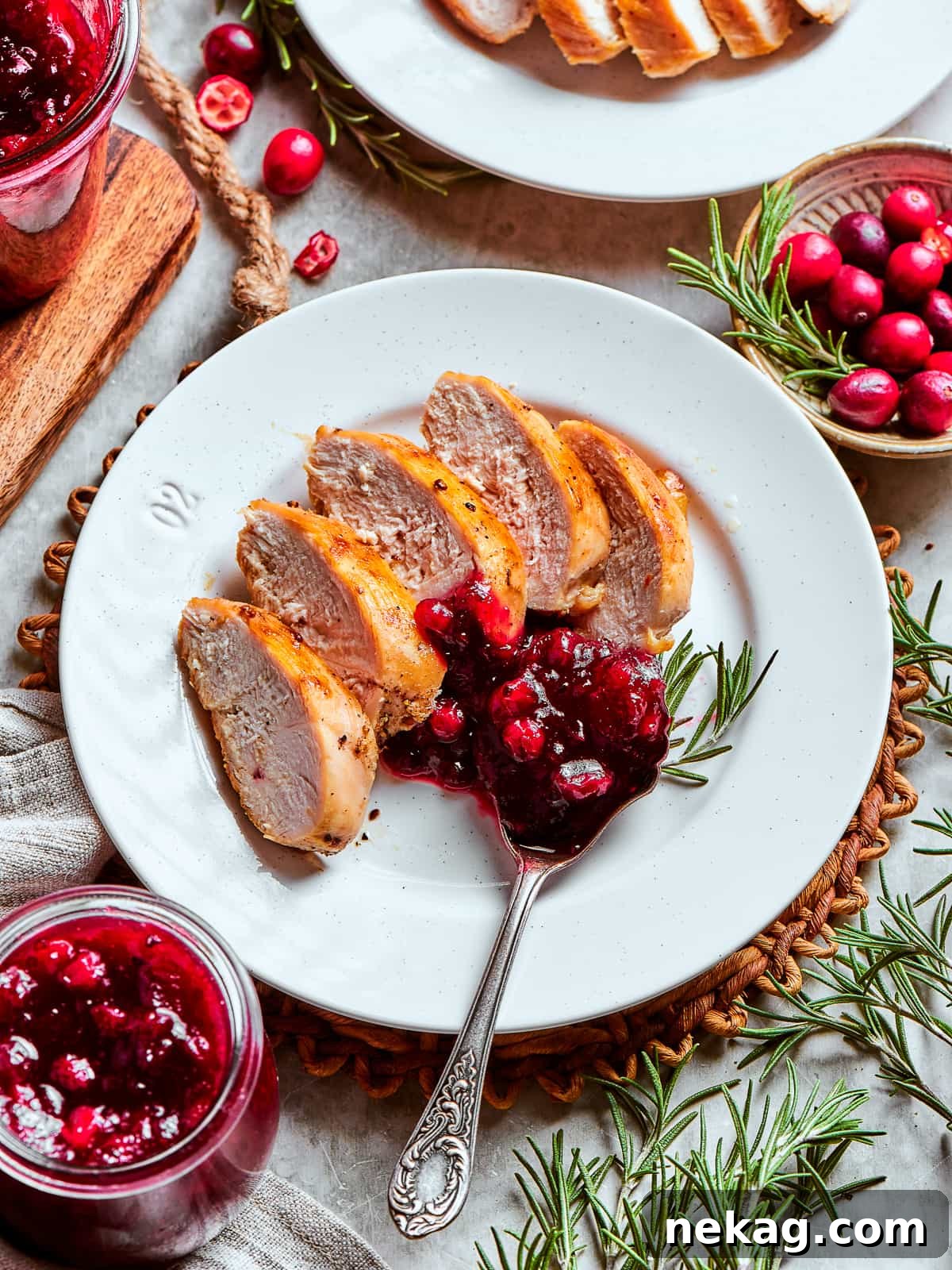 Ruby Red Holiday Delight 9 A generous portion of finished cranberry sauce arranged on a white plate, ready to be served alongside slices of roasted turkey for a festive Thanksgiving dinner.
