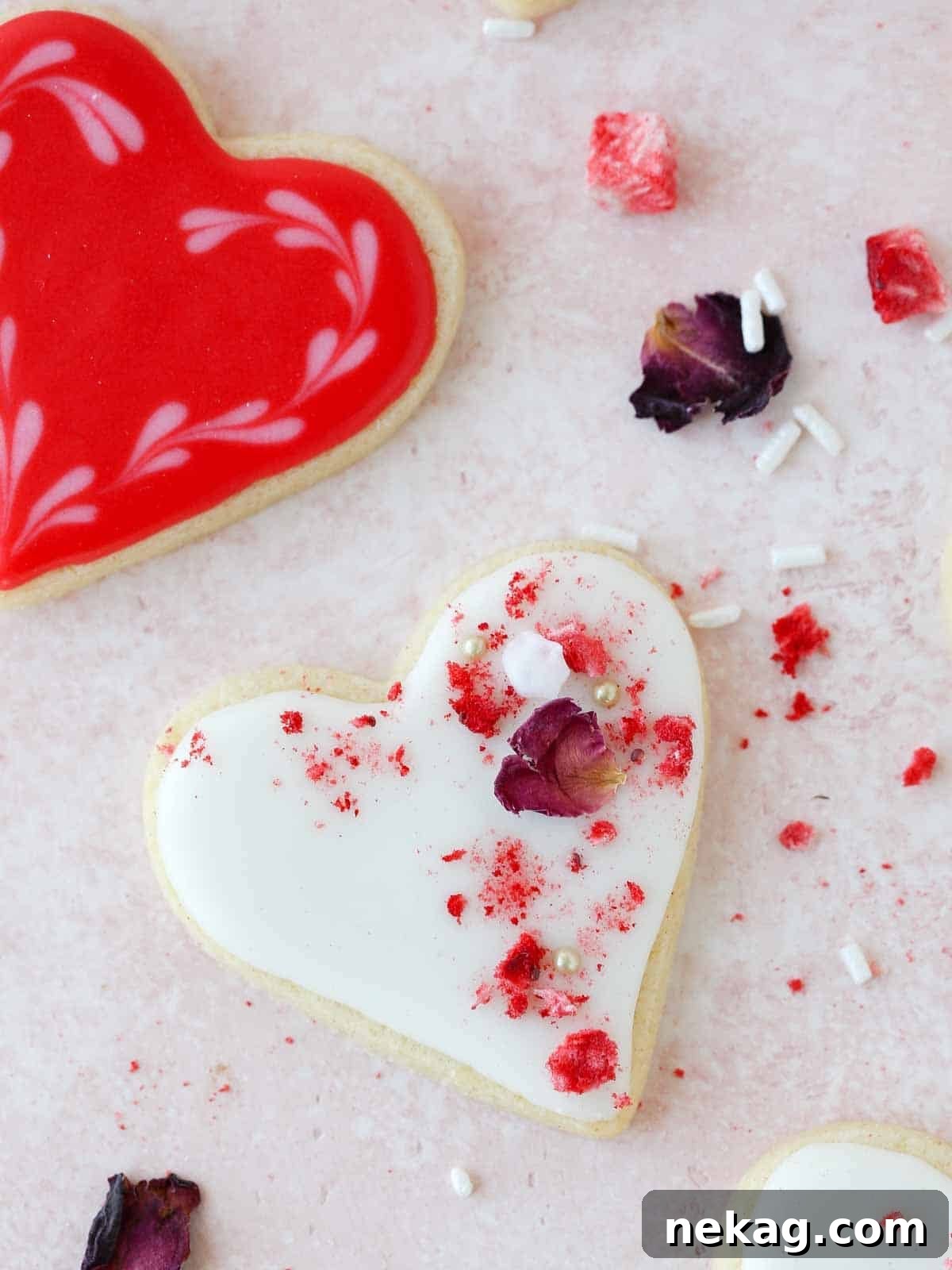 Sweetheart's Delight Cookies 2 Delicately decorated heart-shaped sugar cookies arranged on a festive pink background, perfect for Valentine's Day celebrations.