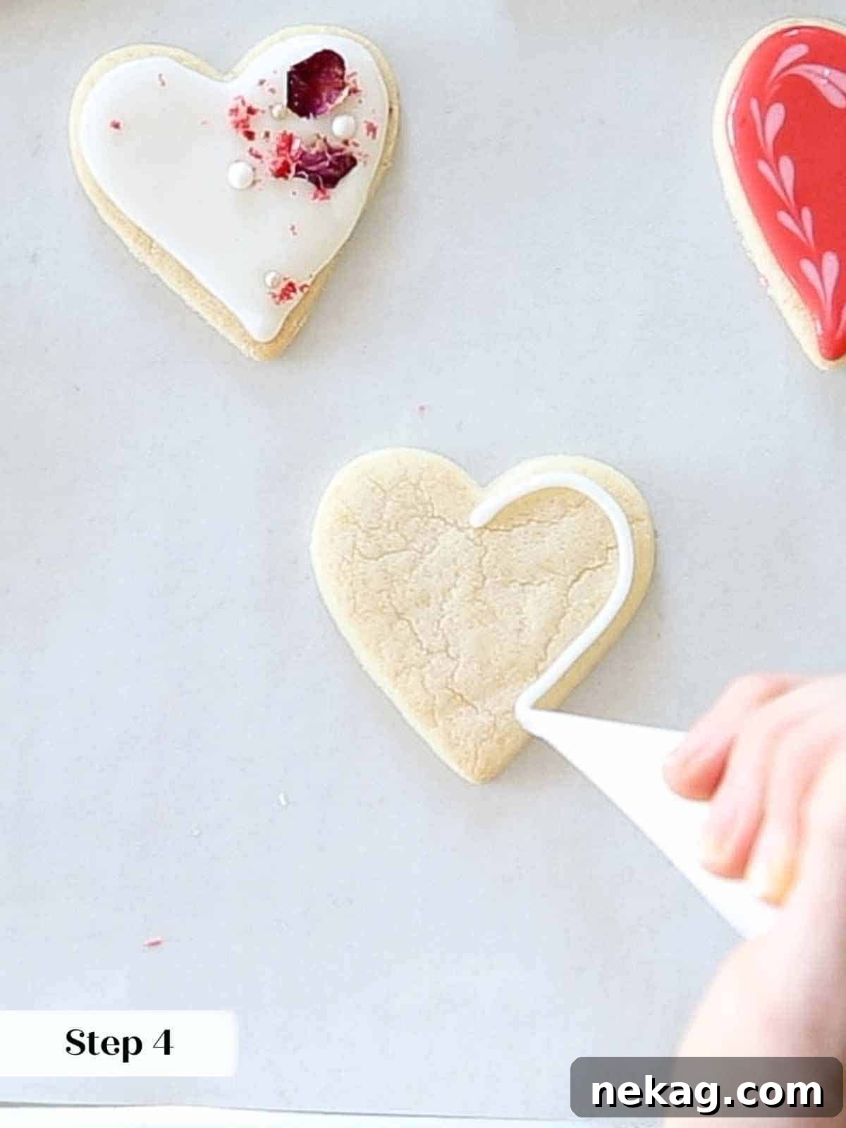 Sweetheart's Delight Cookies 17 A piping bag carefully outlining a heart-shaped sugar cookie with white royal icing, preparing for a contrasting flood or design.