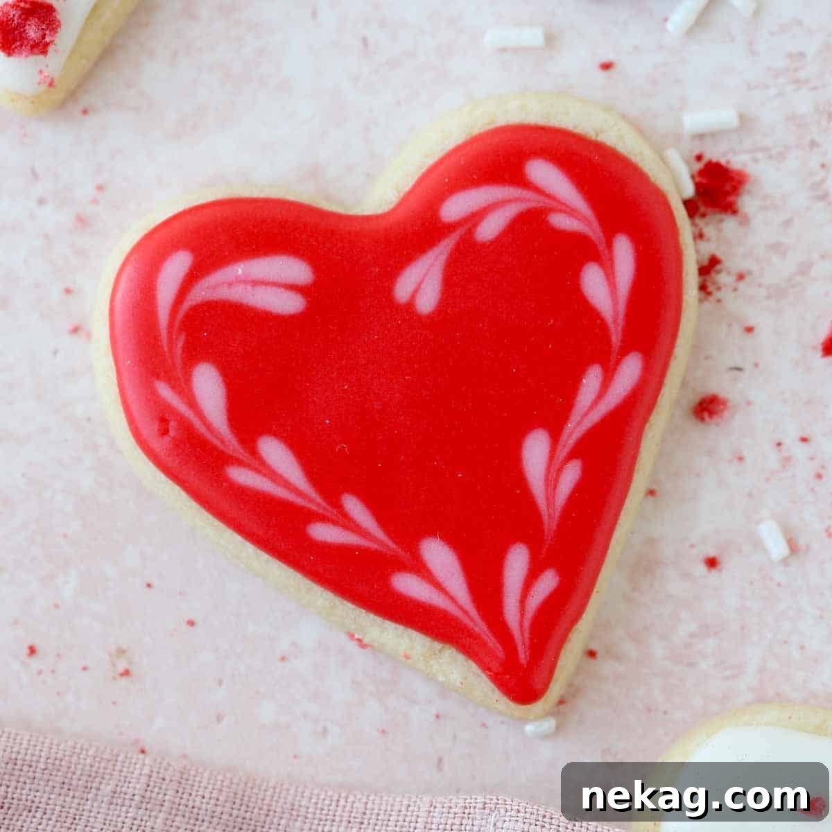 Sweetheart's Delight Cookies 5 A single, perfectly baked and intricately decorated red heart sugar cookie, showcasing a smooth royal icing finish and delicate details.