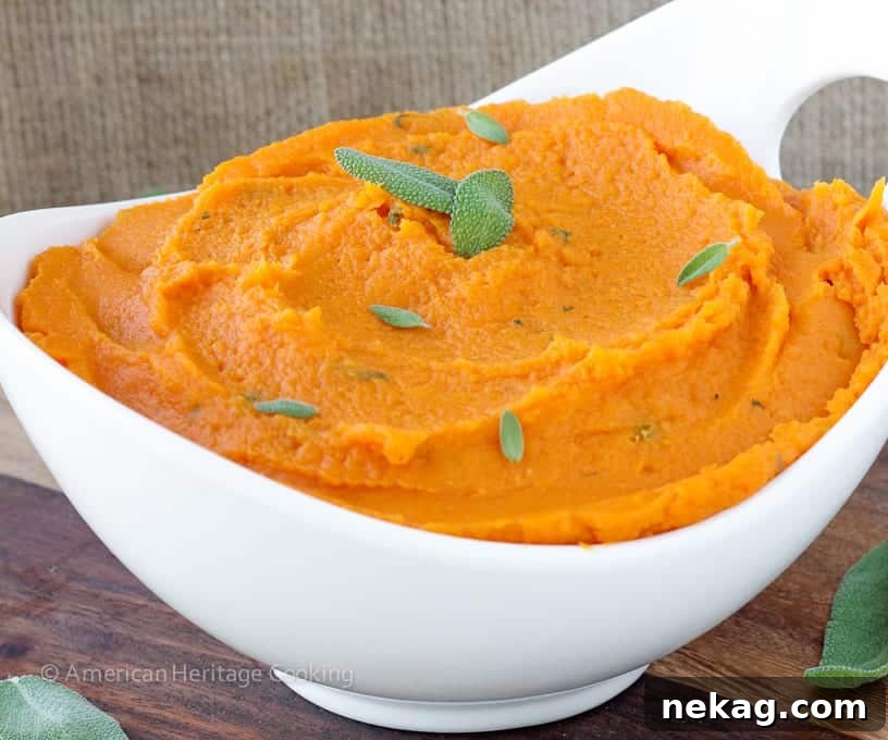 A bowl of creamy mashed sweet potatoes with browned butter and sage, ready for serving.