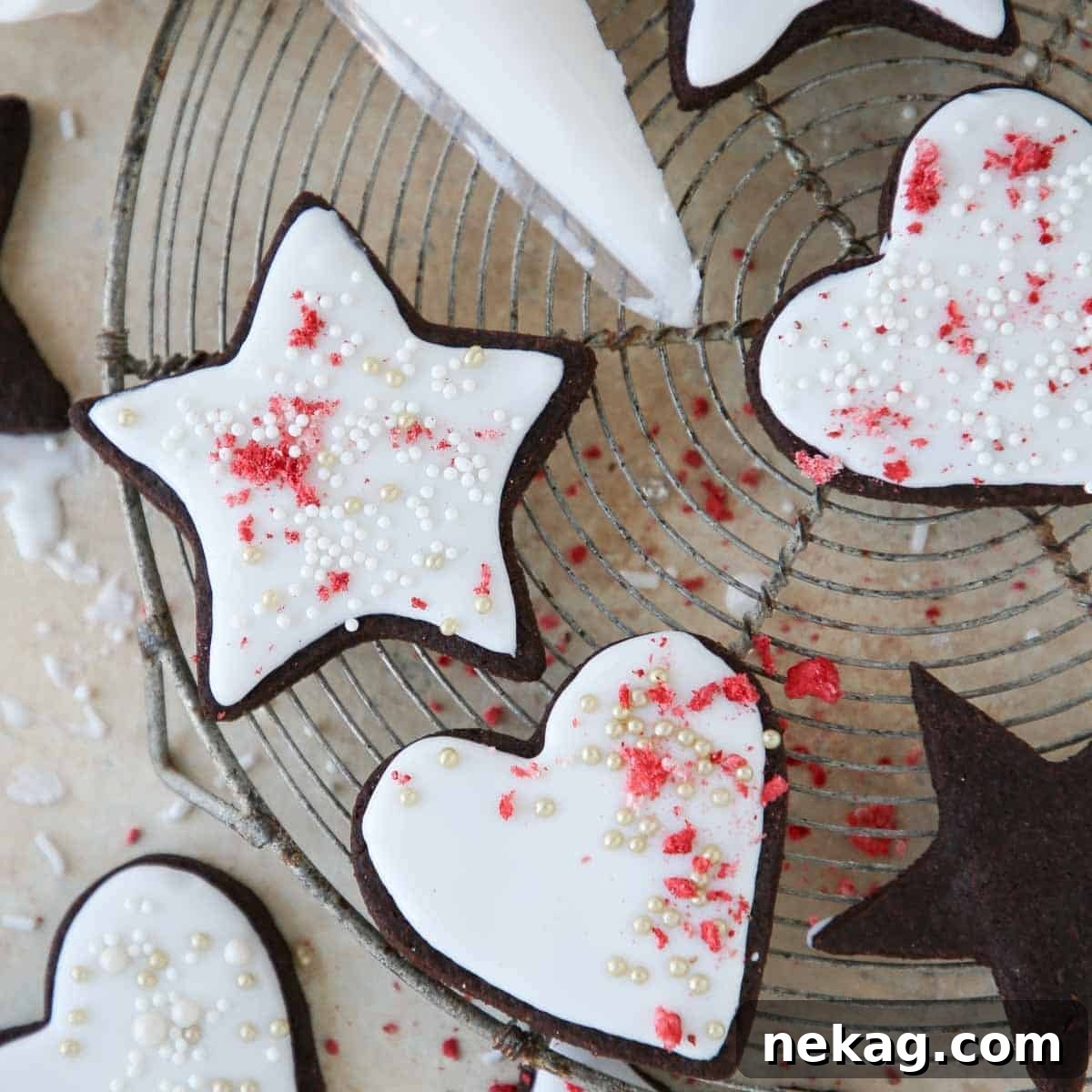 Rich Chocolate Sugar Cookies 14 Perfectly iced chocolate sugar cookies cooling on a wire rack after decoration.