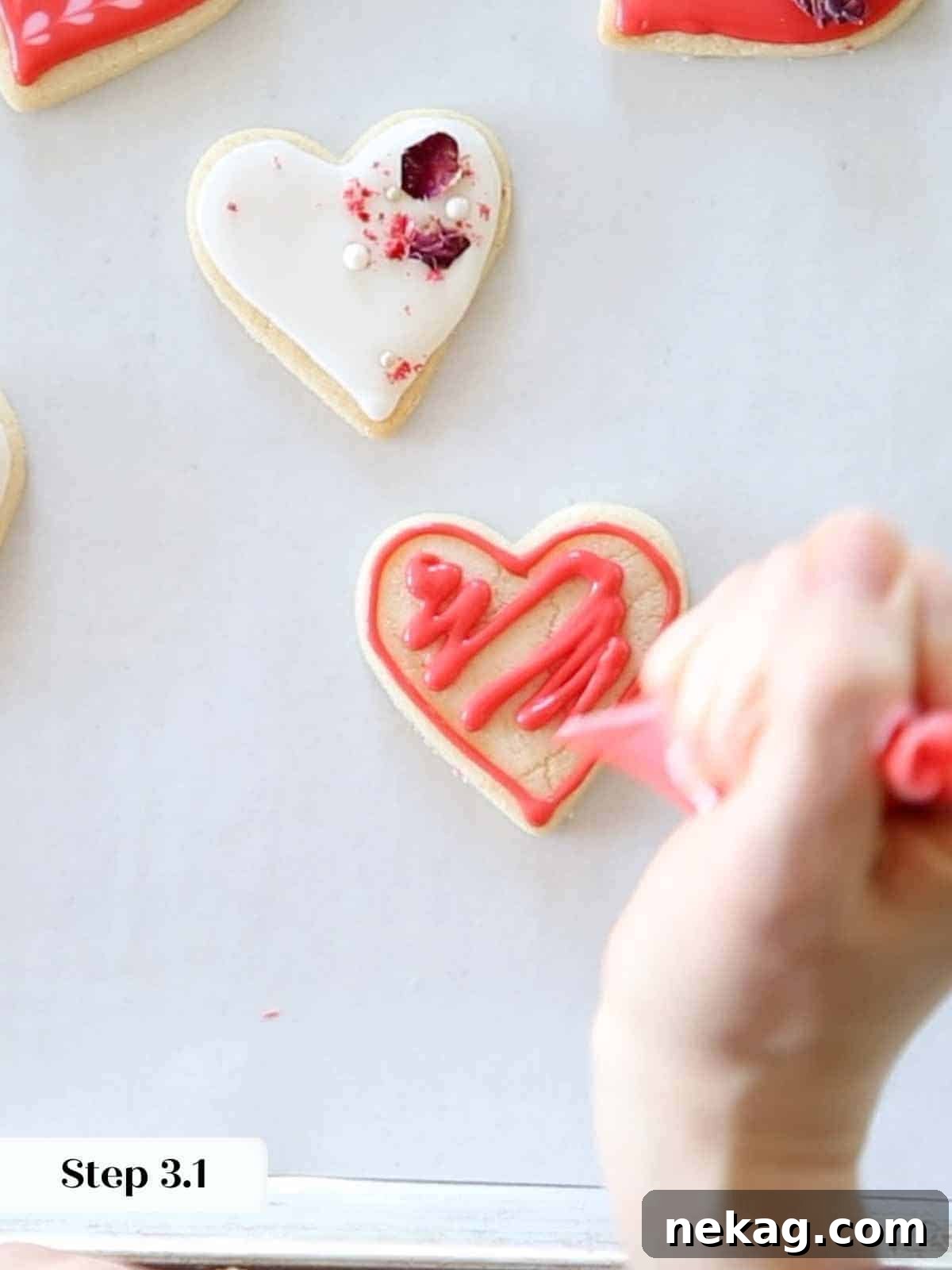 Rich Chocolate Sugar Cookies 6 A squiggly pattern of red royal icing is applied within the outline of a heart cookie, preparing for flooding.