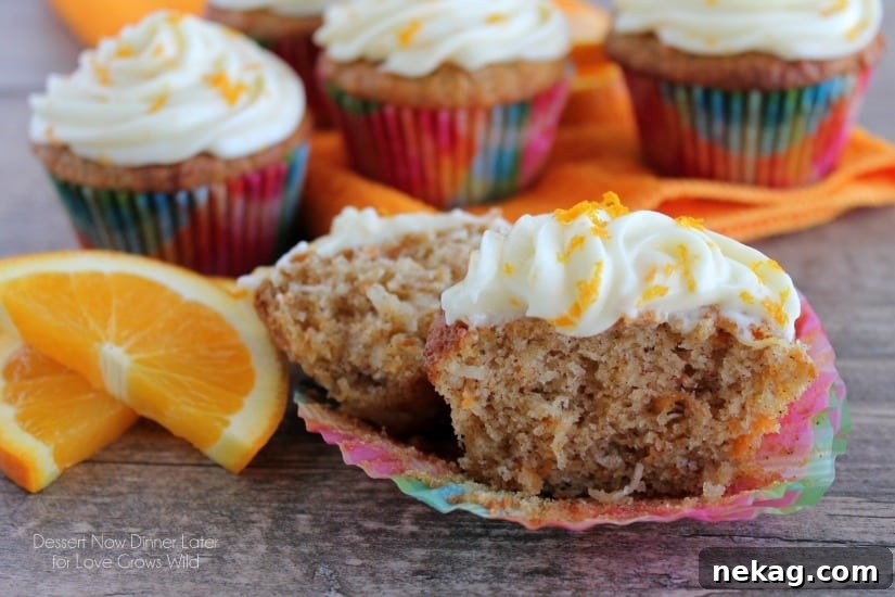 Beautifully frosted Coconut Carrot Cake Cupcakes garnished with orange zest