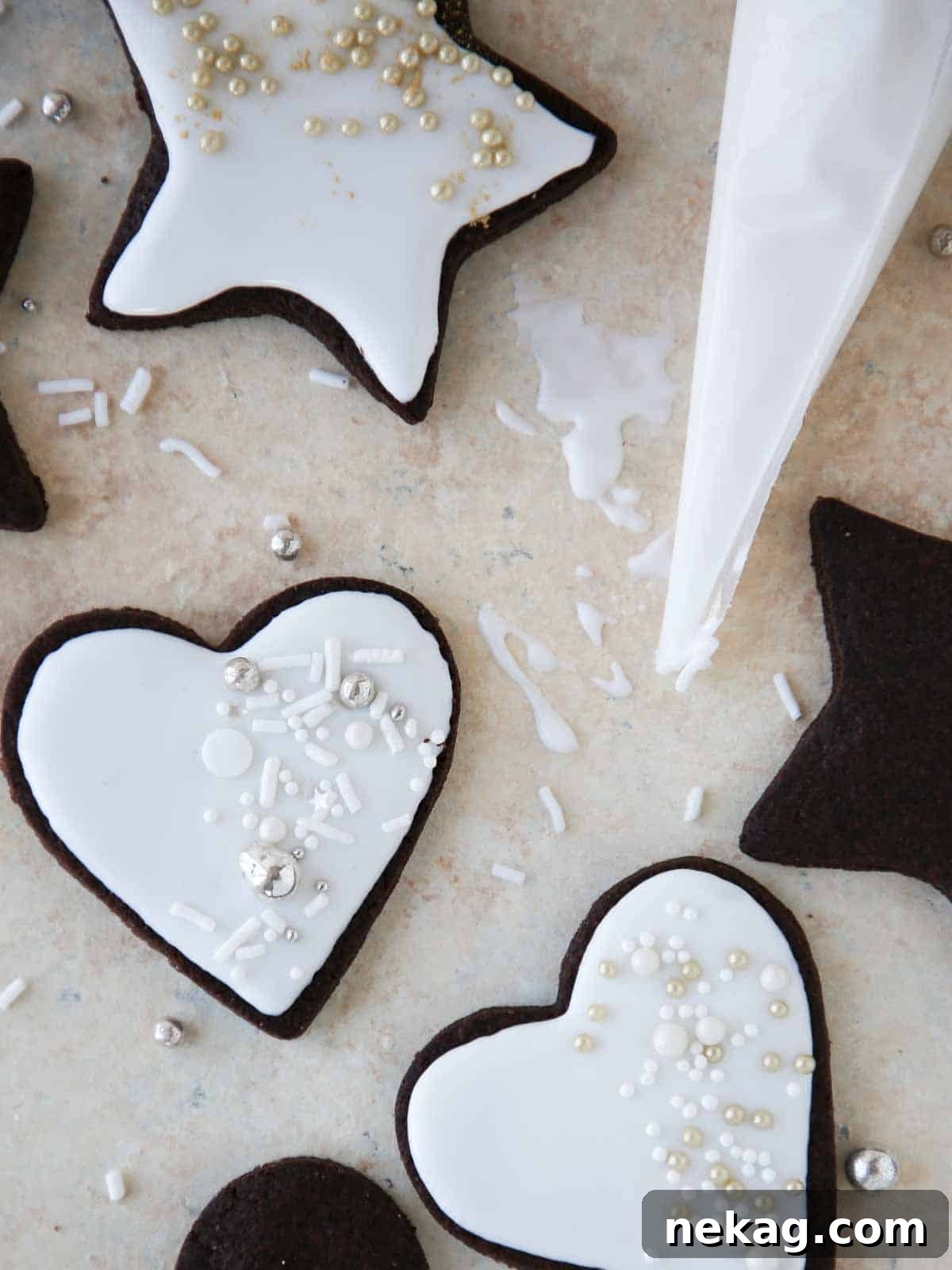 Easy cookie icing on a variety of decorated sugar cookies resting on a creamy surface.
