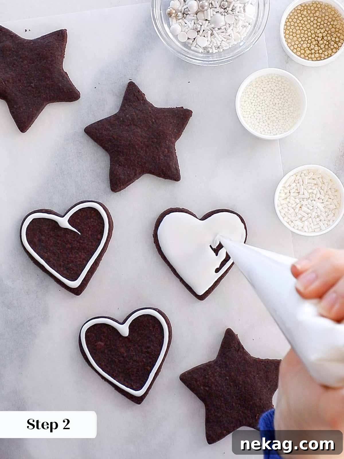 Flooding the interior of a chocolate sugar cookie with an even layer of easy cookie icing.