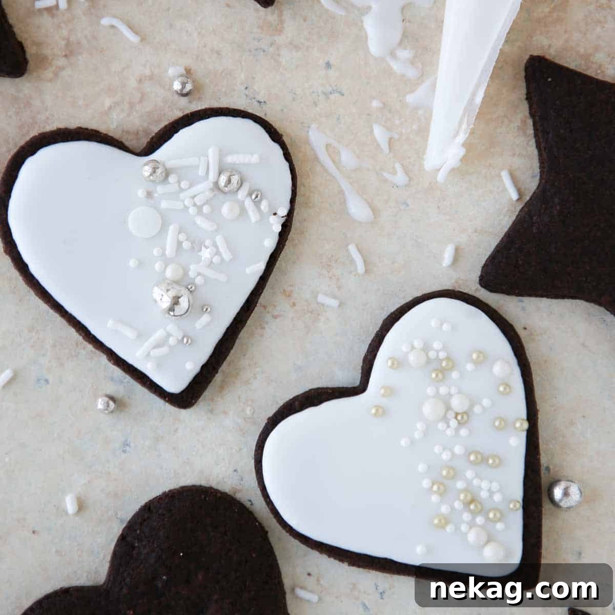 A selection of beautifully iced cookies, some adorned with sprinkles, showcasing the perfect texture and shine of the easy cookie icing.