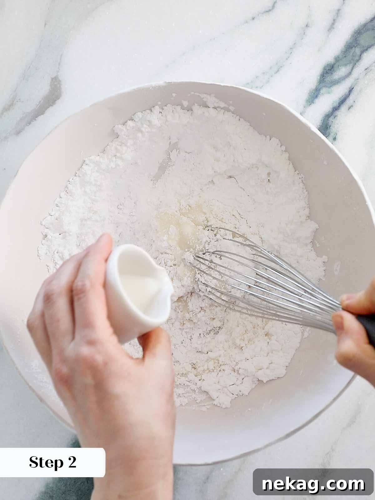 Whisking all ingredients together thoroughly to create a smooth and consistent easy cookie icing.