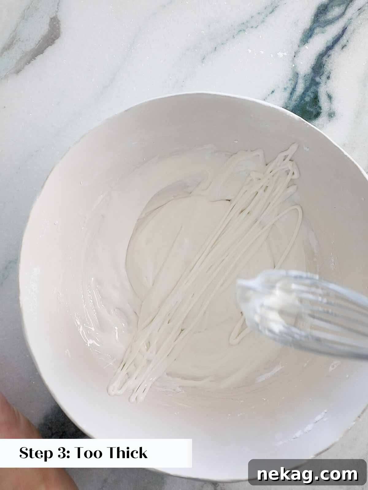 Close-up of icing that is too thick, indicating it's not ideal for flooding cookies.