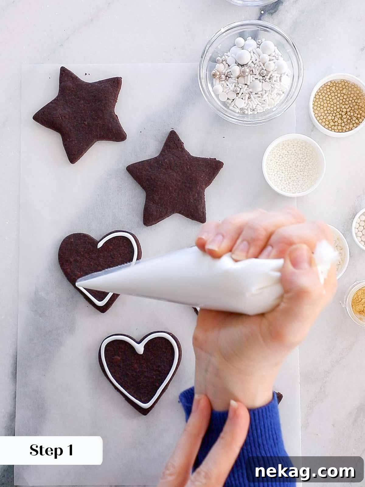 Outlining a chocolate sugar cookie with smooth, easy cookie icing using a piping bag.