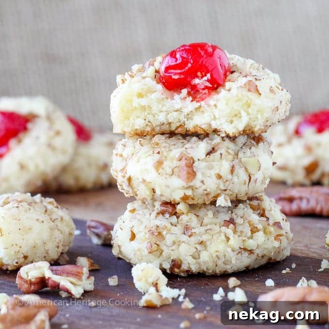 A tray of freshly baked cherry pecan cookies cooling on a wire rack.