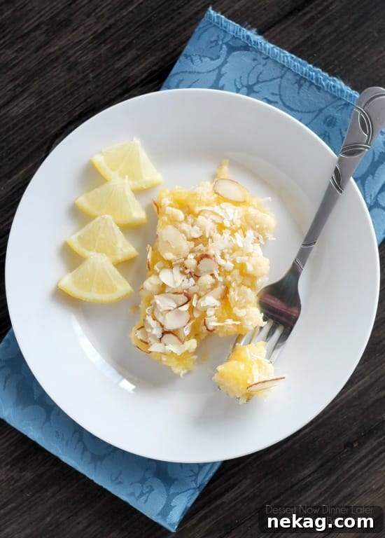 Close-up of a Lemon Curd Bar showing the thick, creamy lemon layer and golden crust.