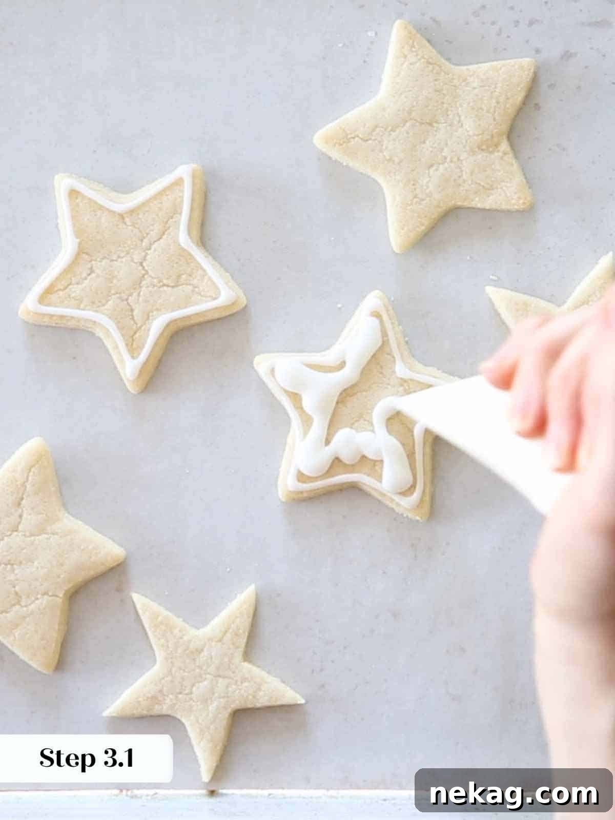 squiggling white royal icing on sugar cookie stars.
