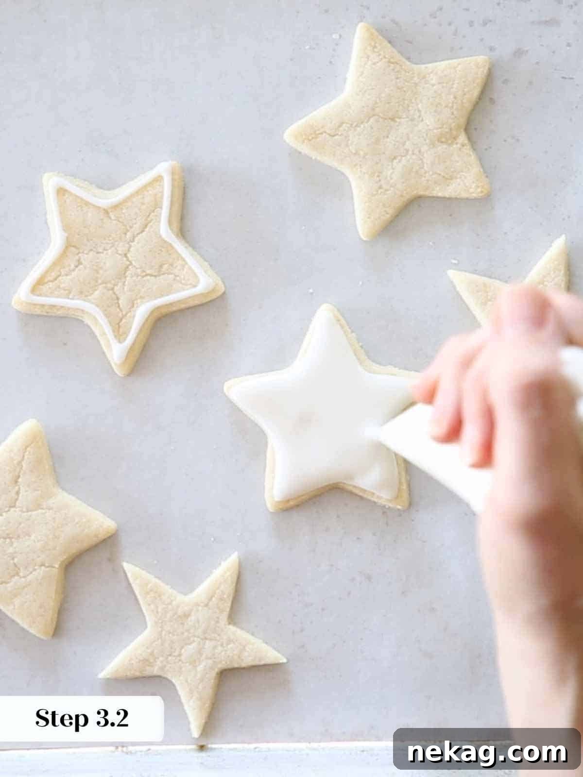 flooding white royal icing on sugar cookie stars.