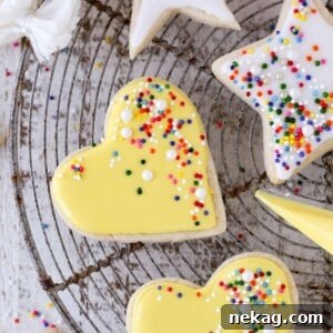 icing yellow heart shaped sugar cookies.