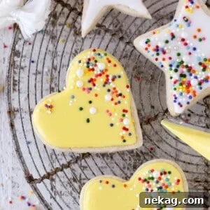 icing yellow heart shaped sugar cookies.