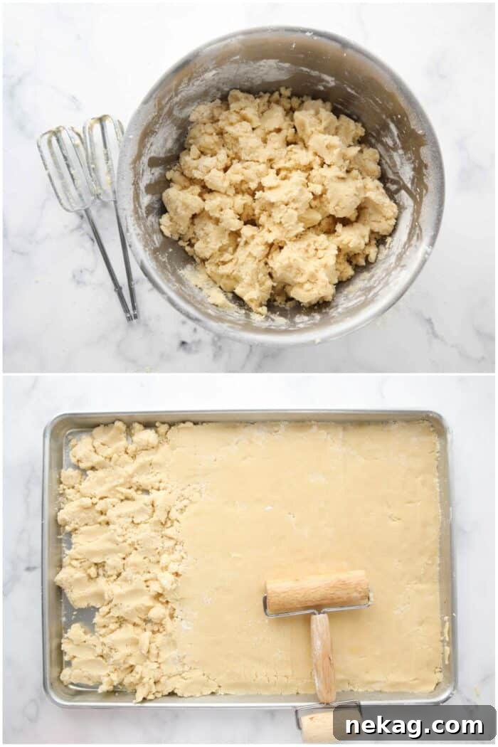 Transferring the finished almond cookie dough to the prepared sheet pan and making it smooth with a pastry roller.