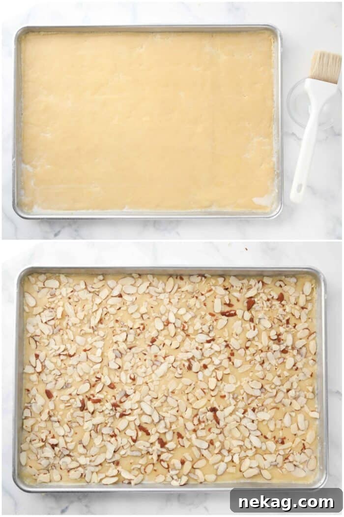 Brushing the top of the dough with milk, then topping with sliced almonds.
